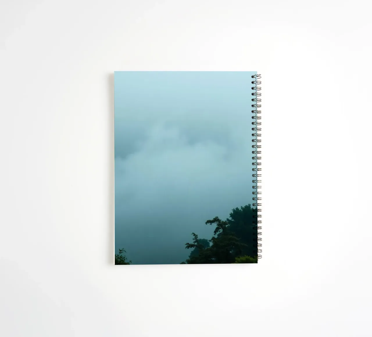 Foggy landscape with trees, creating calming atmosphere spiral notebook by DesignDoodle