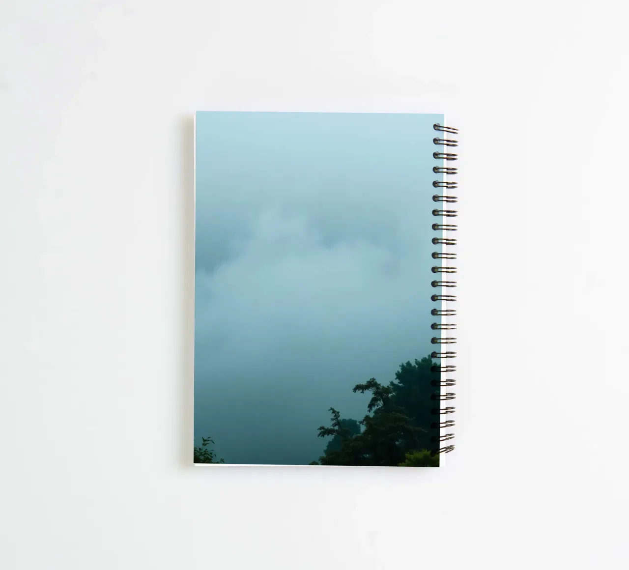 Foggy landscape with trees, creating calming atmosphere spiral notebook by DesignDoodle