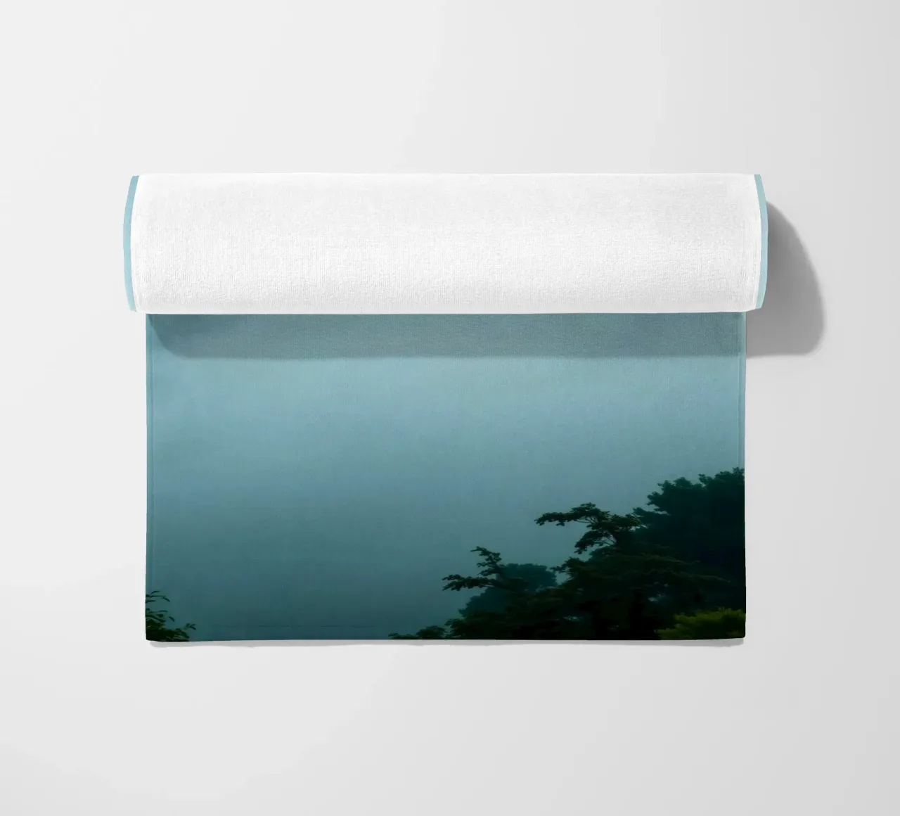 Foggy landscape with trees, creating calming atmosphere beach towel by DesignDoodle