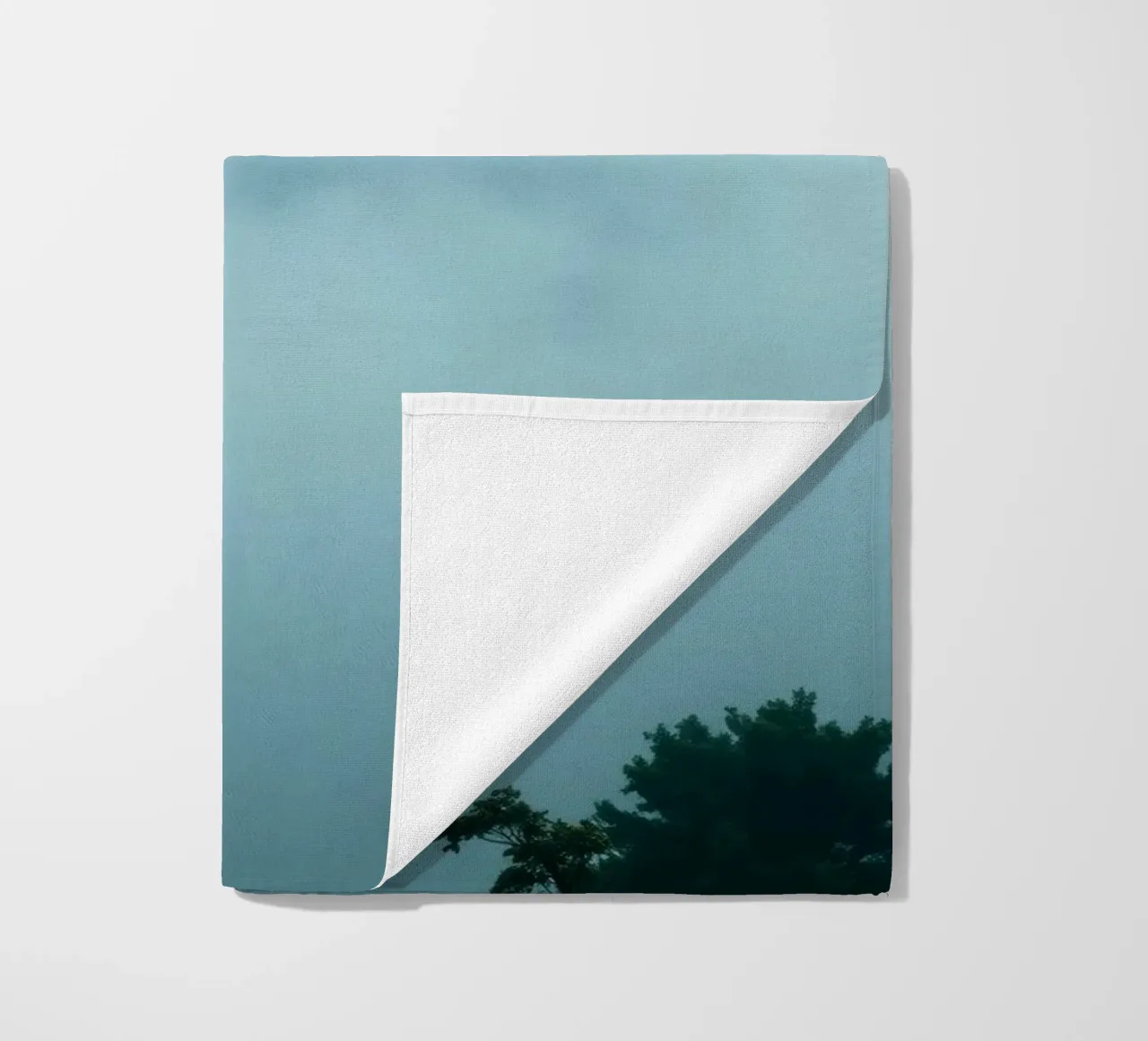 Foggy landscape with trees, creating calming atmosphere beach towel by DesignDoodle