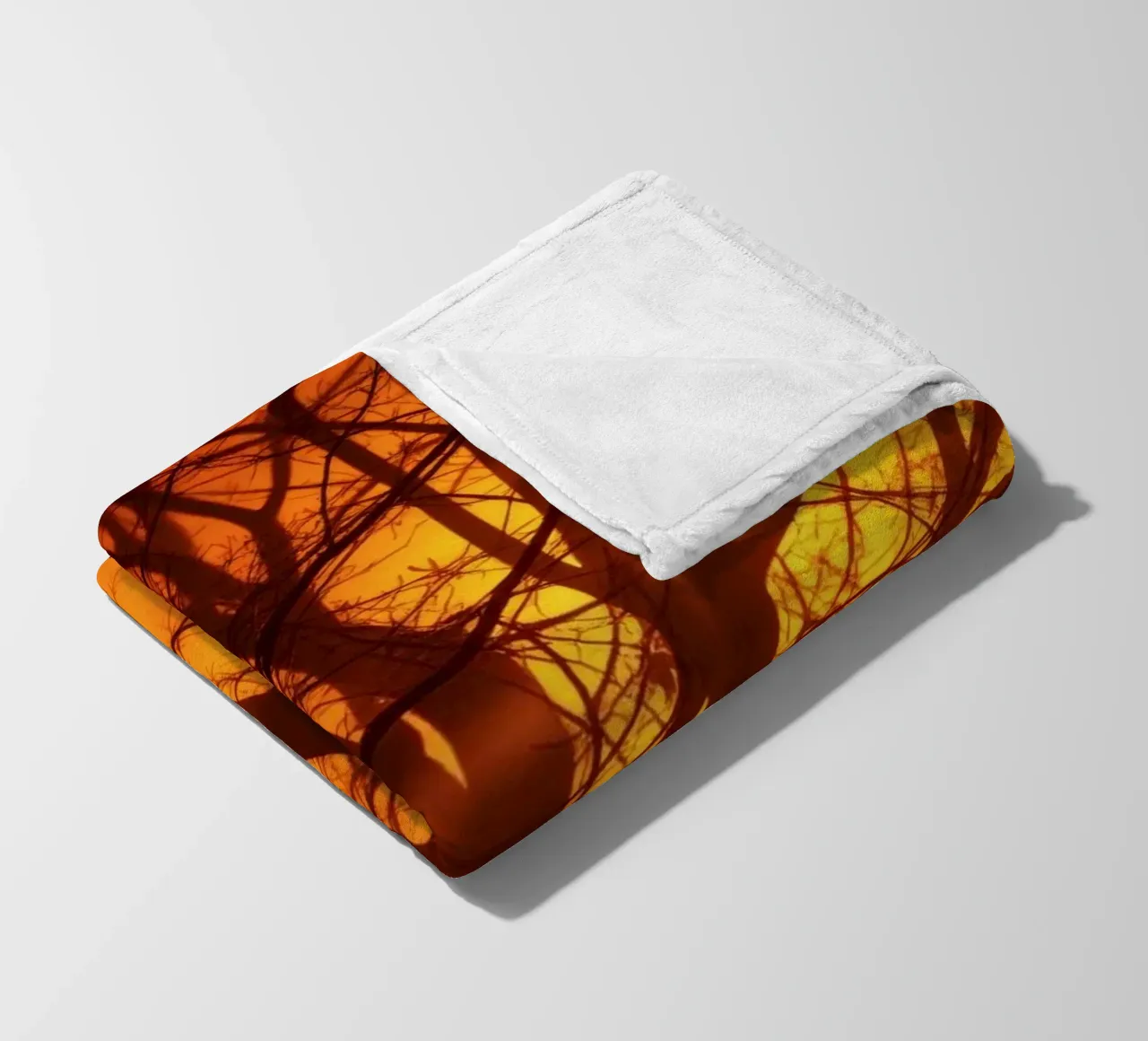silhouette of a tree against a vibrant orange background wit fleece blanket by DesignDoodle