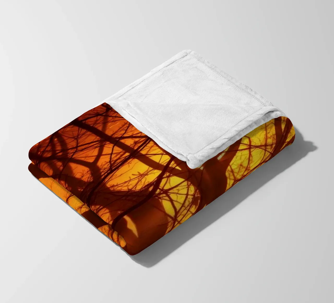silhouette of a tree against a vibrant orange background wit fleece blanket by DesignDoodle