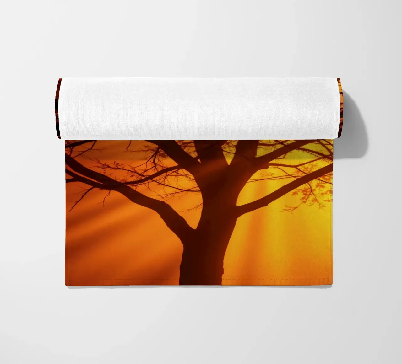 silhouette of a tree against a vibrant orange background wit beach towel by DesignDoodle