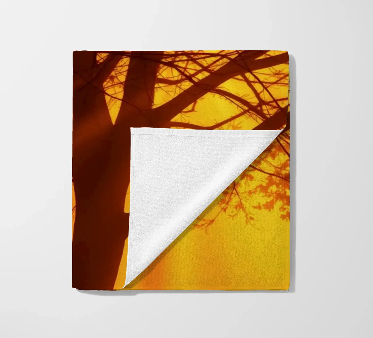 silhouette of a tree against a vibrant orange background wit beach towel by DesignDoodle