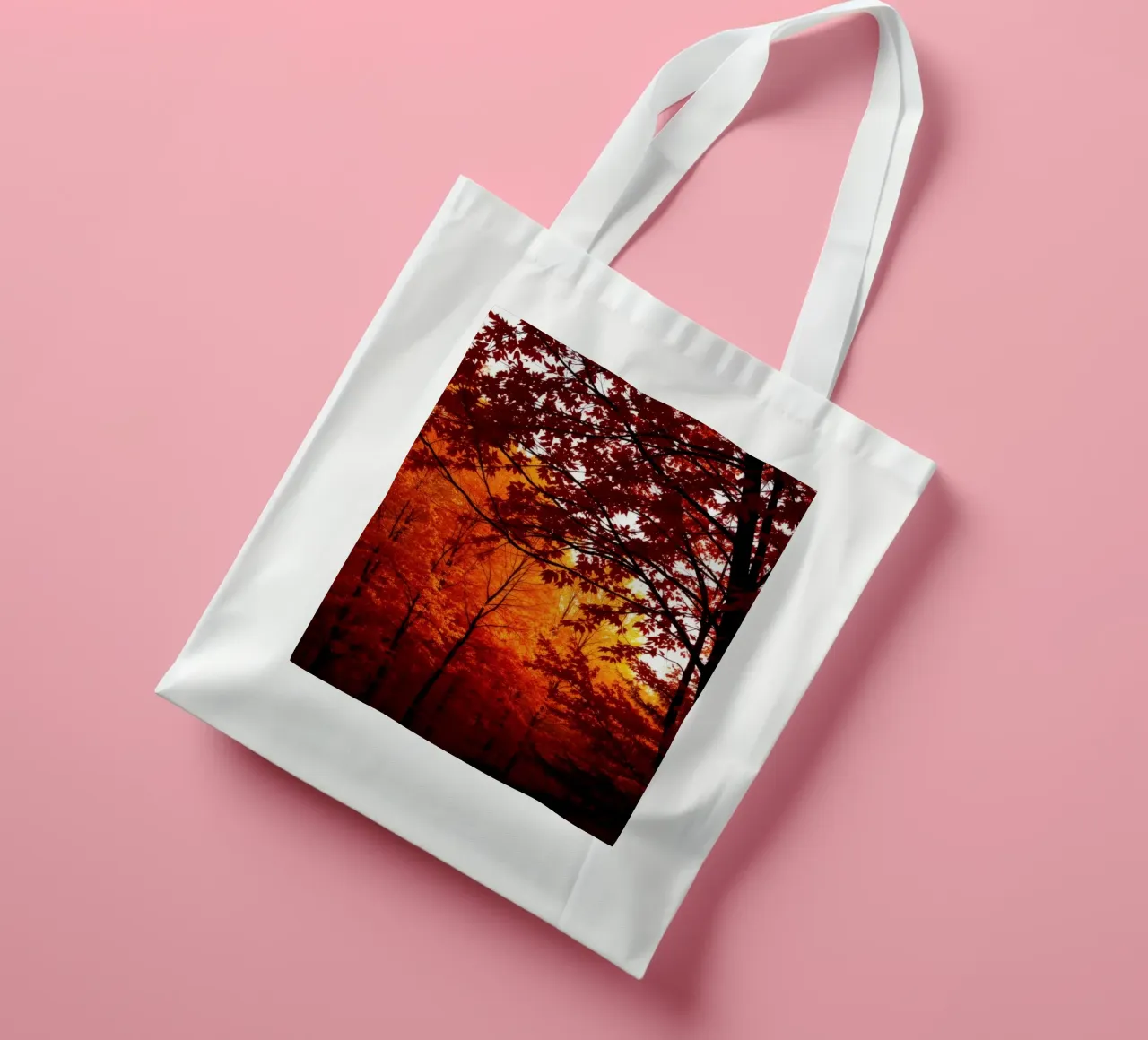autumn foliage creating vibrant tapestry of reds and orange tote bag by DesignDoodle