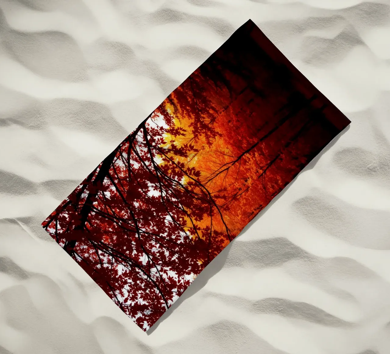 autumn foliage creating vibrant tapestry of reds and orange beach towel by DesignDoodle