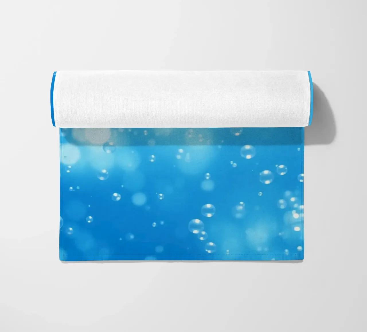 Bubbles floating in clear blue water creating calm art beach towel by DesignDoodle