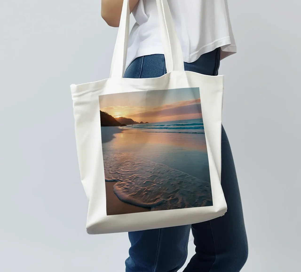 Sunset glow over tranquil beach with gentle waves tote bag by DesignDoodle