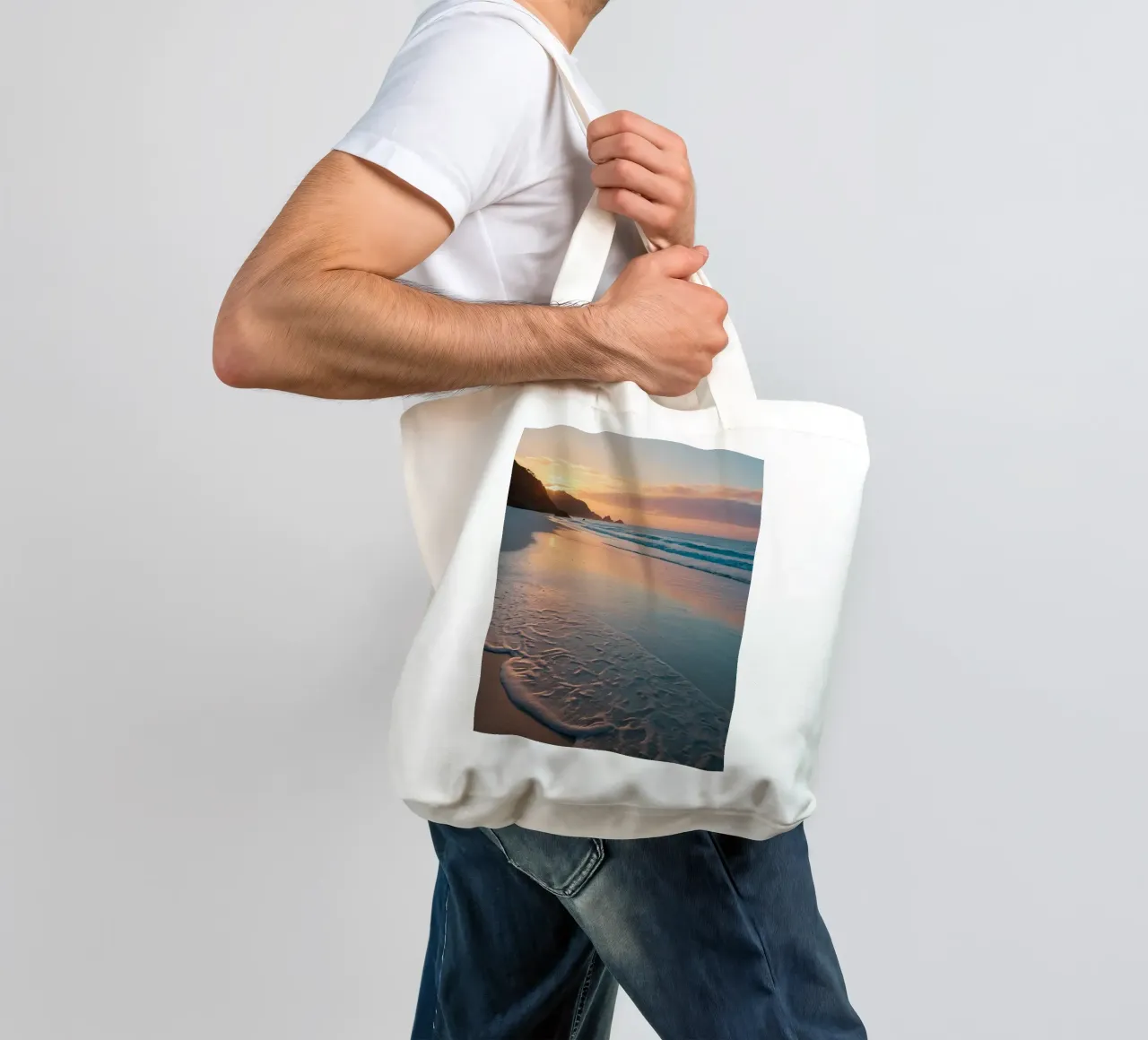 Sunset glow over tranquil beach with gentle waves tote bag by DesignDoodle