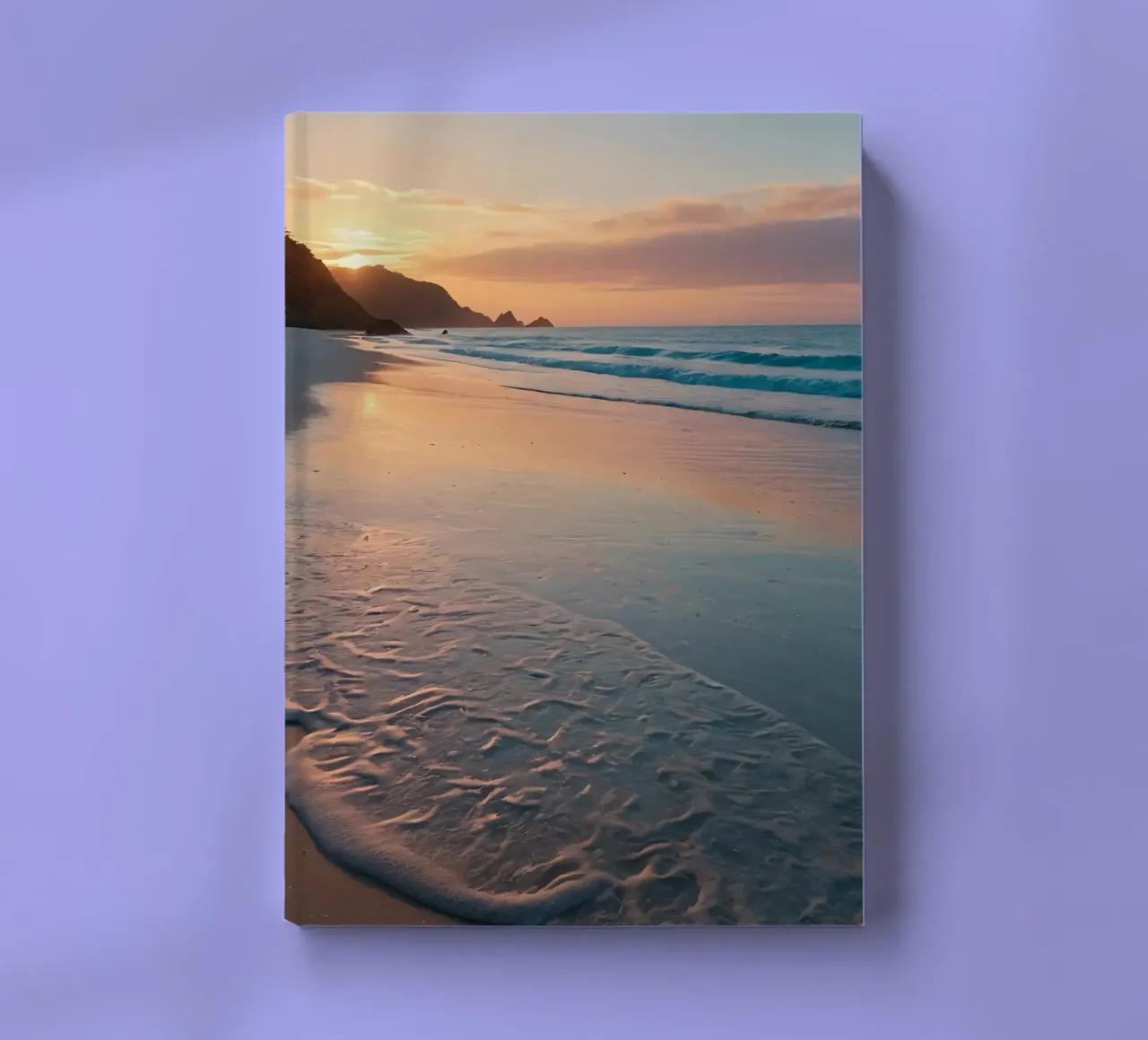Sunset glow over tranquil beach with gentle waves notebook by DesignDoodle
