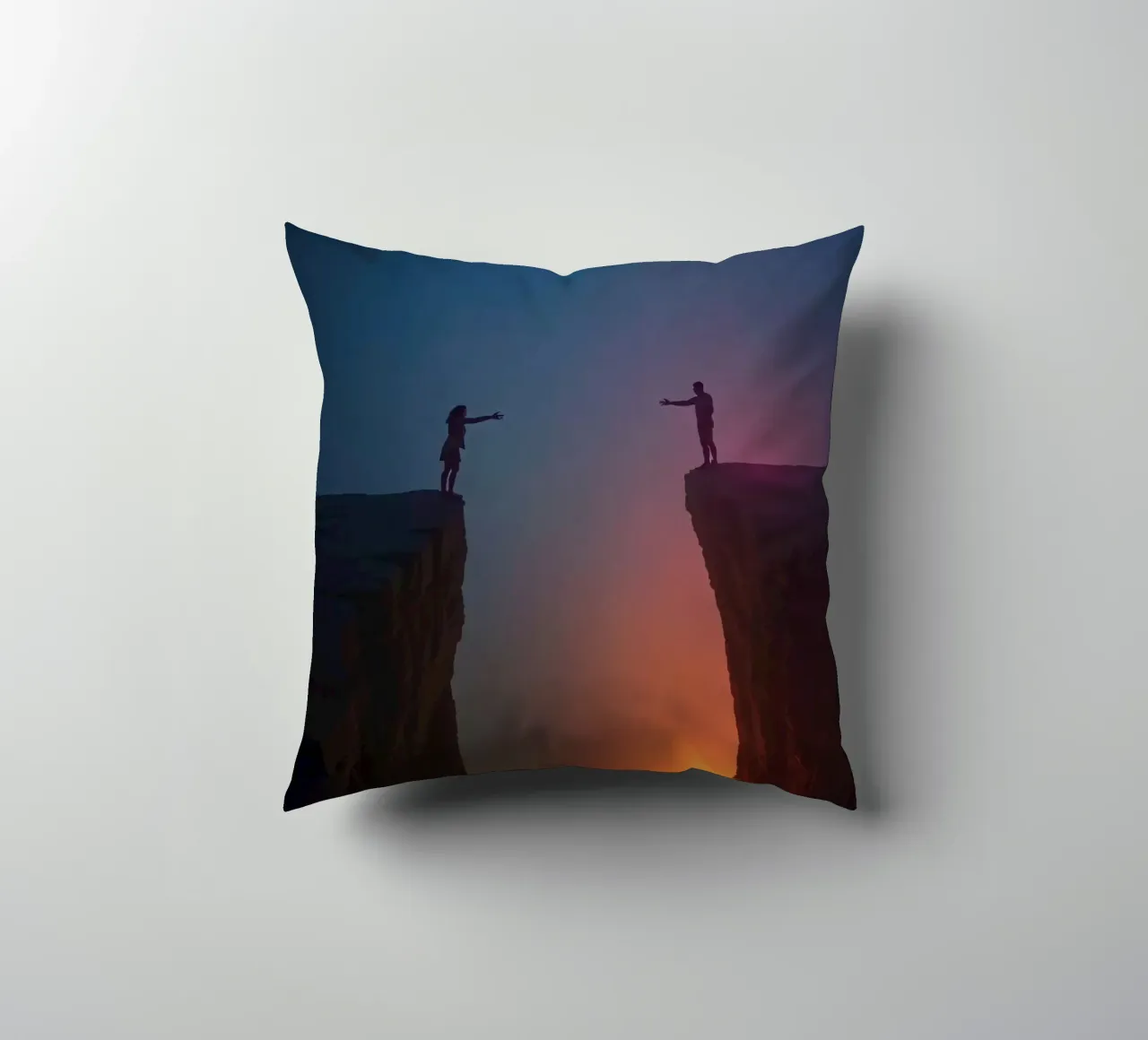 Due persone che si tendono la mano attraverso un abisso cuscino da DesignDoodle