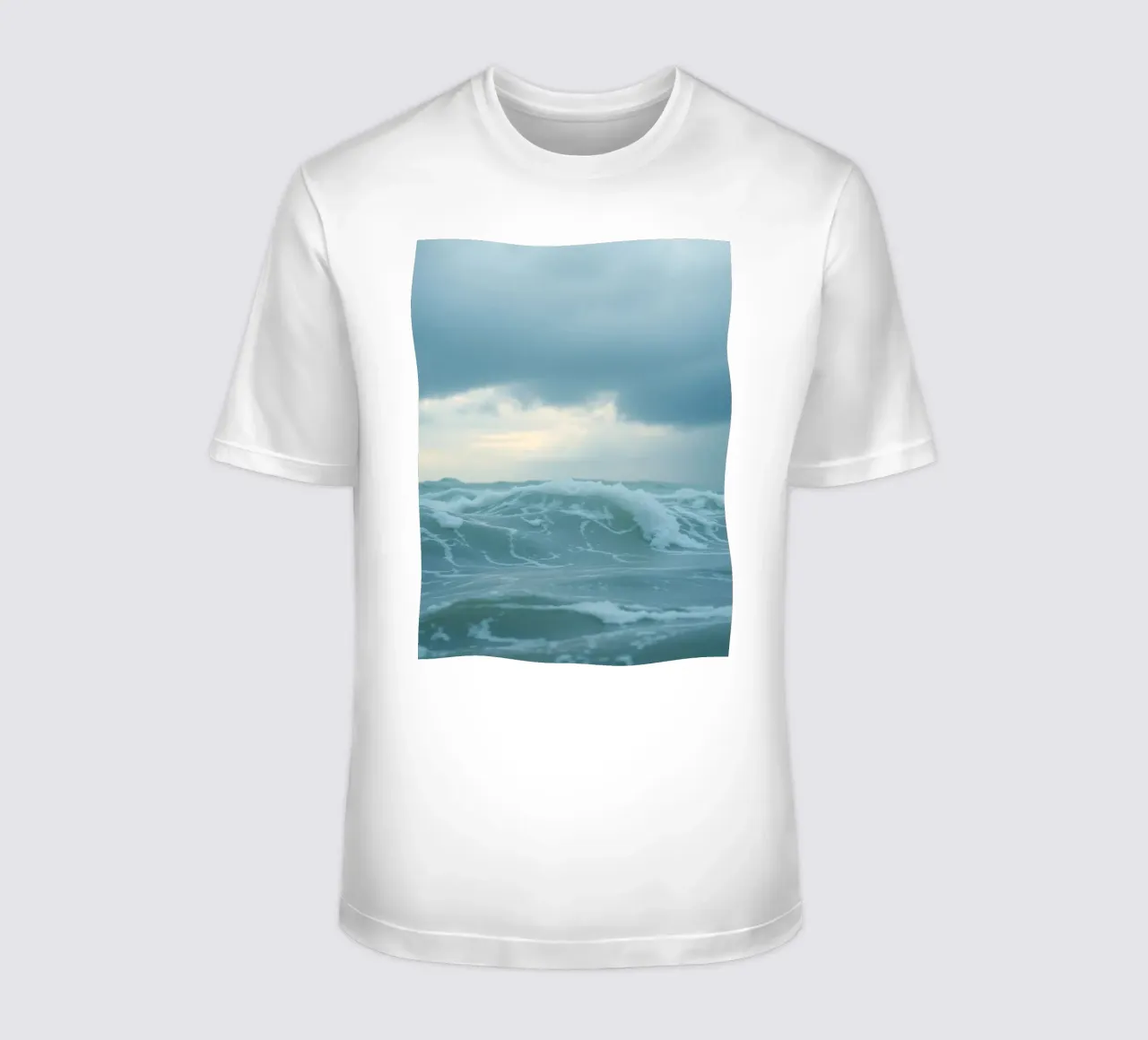 Waves crash against the shore under dark clouds at twilight t-shirt by DesignDoodle