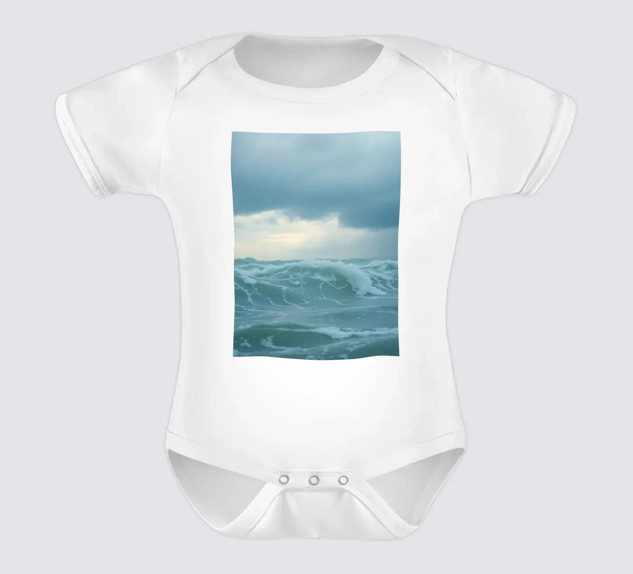 Waves crash against the shore under dark clouds at twilight short-sleeve baby romper by DesignDoodle