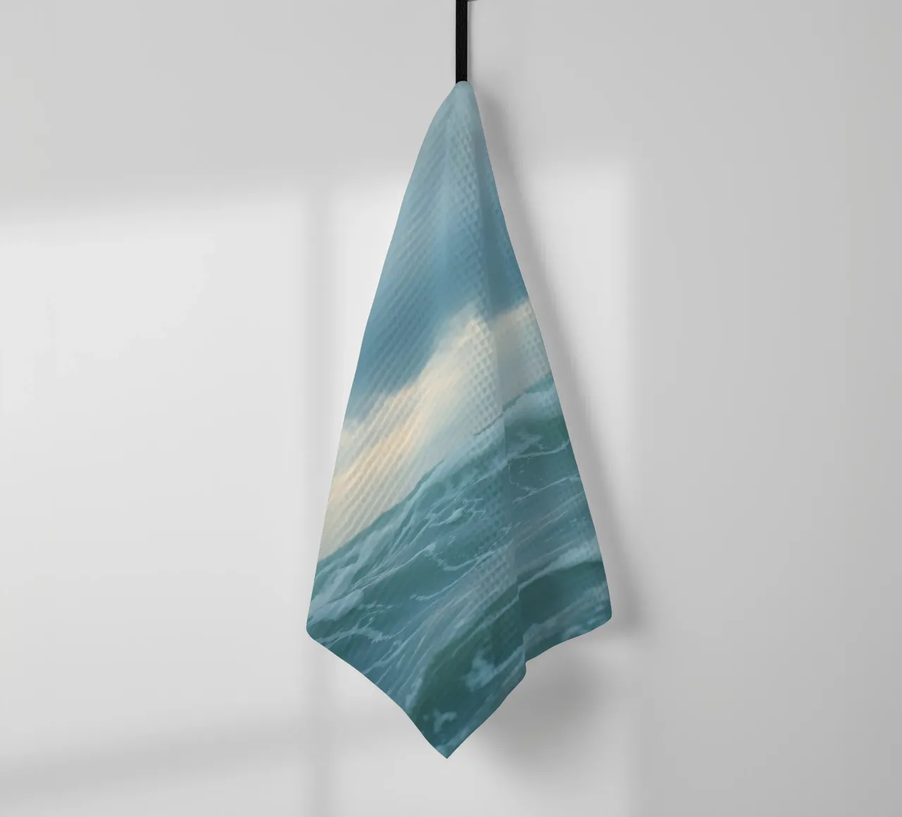 Waves crash against the shore under dark clouds at twilight tea towel by DesignDoodle