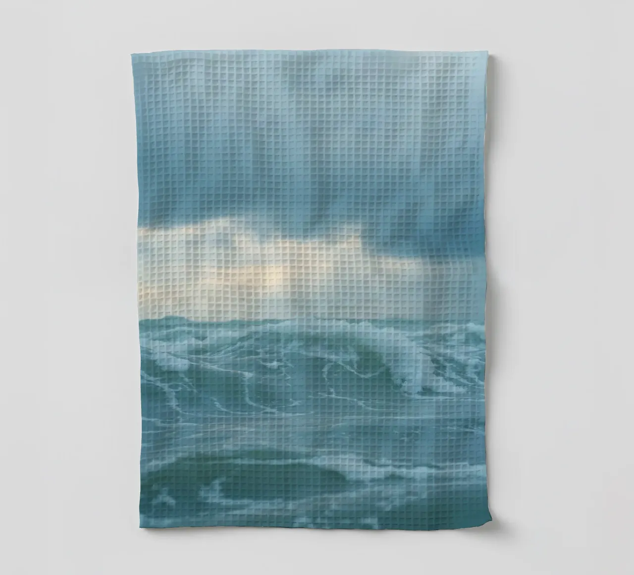 Waves crash against the shore under dark clouds at twilight tea towel by DesignDoodle