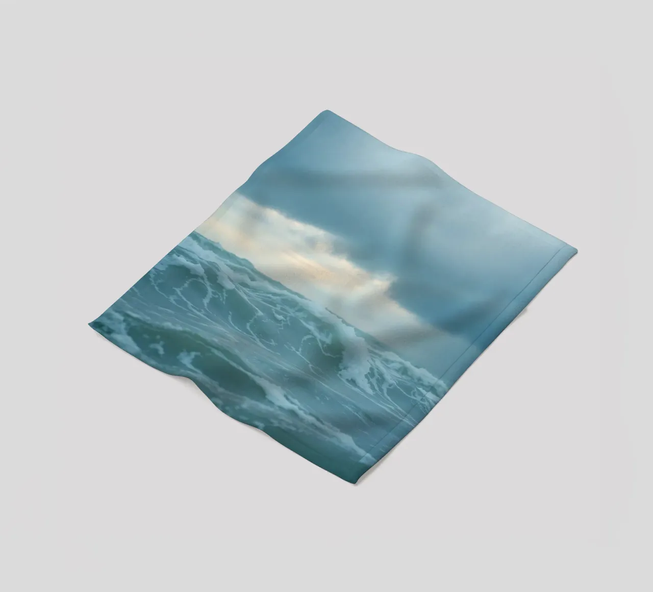 Waves crash against the shore under dark clouds at twilight fleece blanket by DesignDoodle