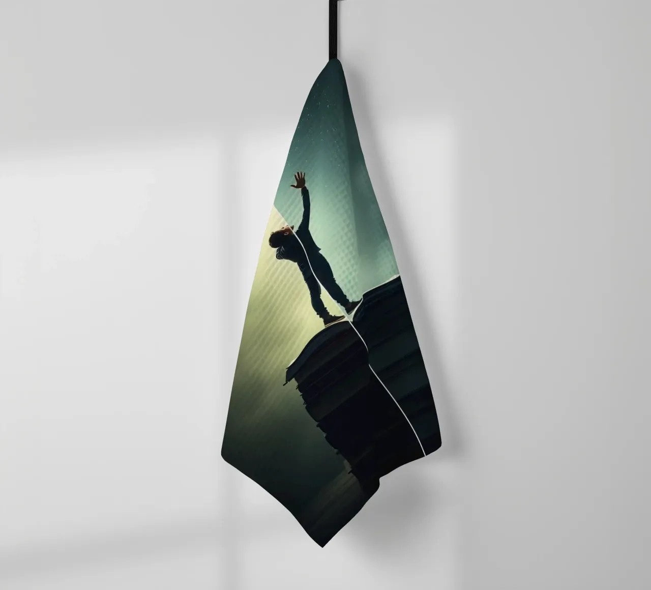 man reaches for stars while standing on a stack of books tea towel by DesignDoodle