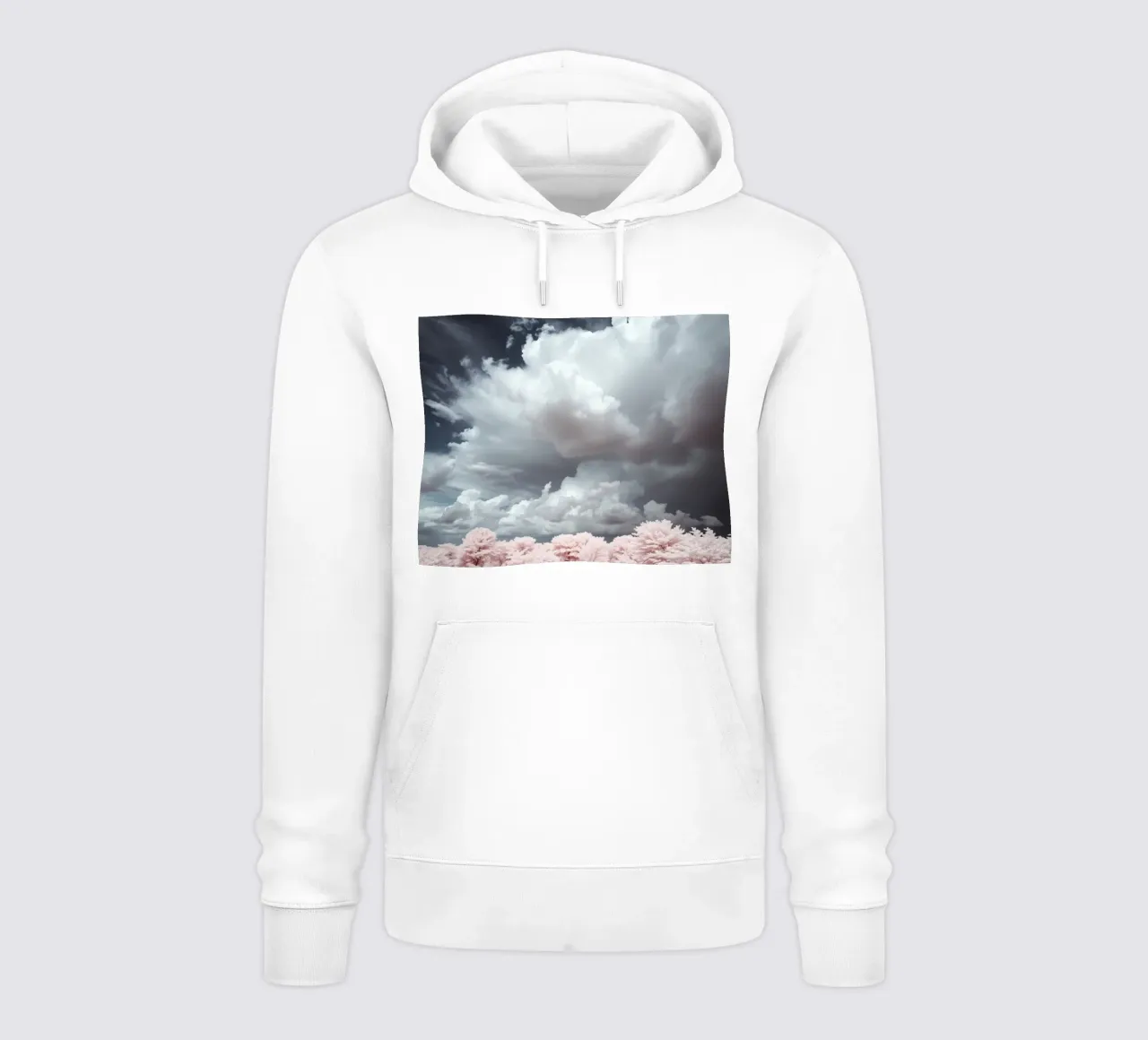 Dramatic clouds hover over pink-tinted trees in an enchantin hoodie by DesignDoodle
