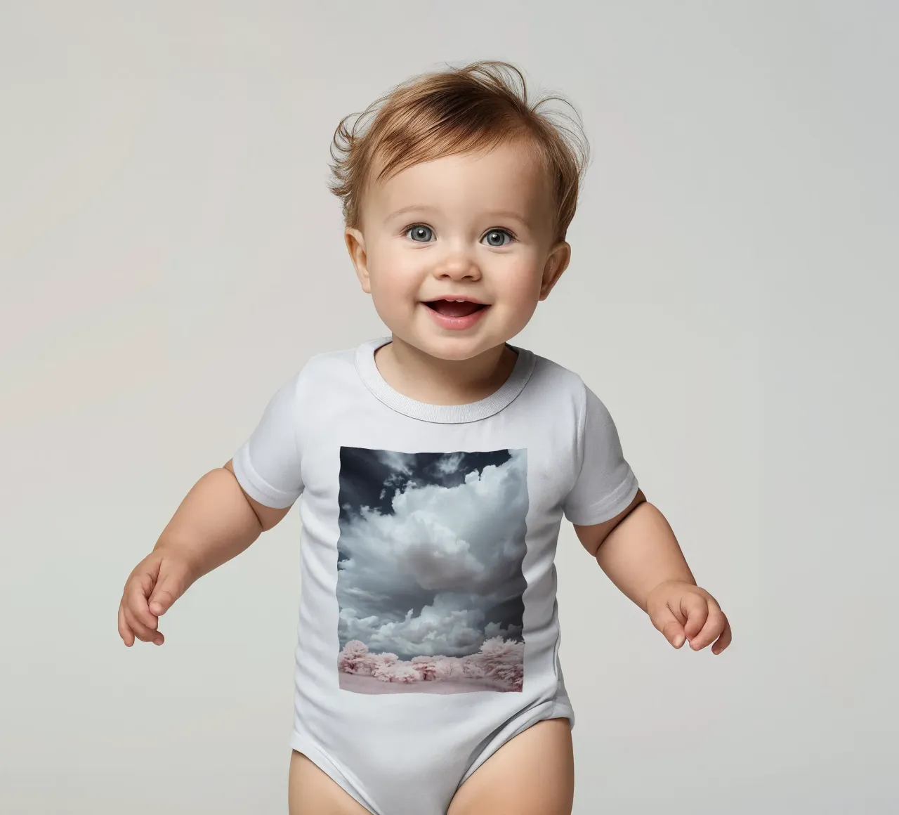 Dramatic clouds hover over pink-tinted trees in an enchantin short-sleeve baby romper by DesignDoodle