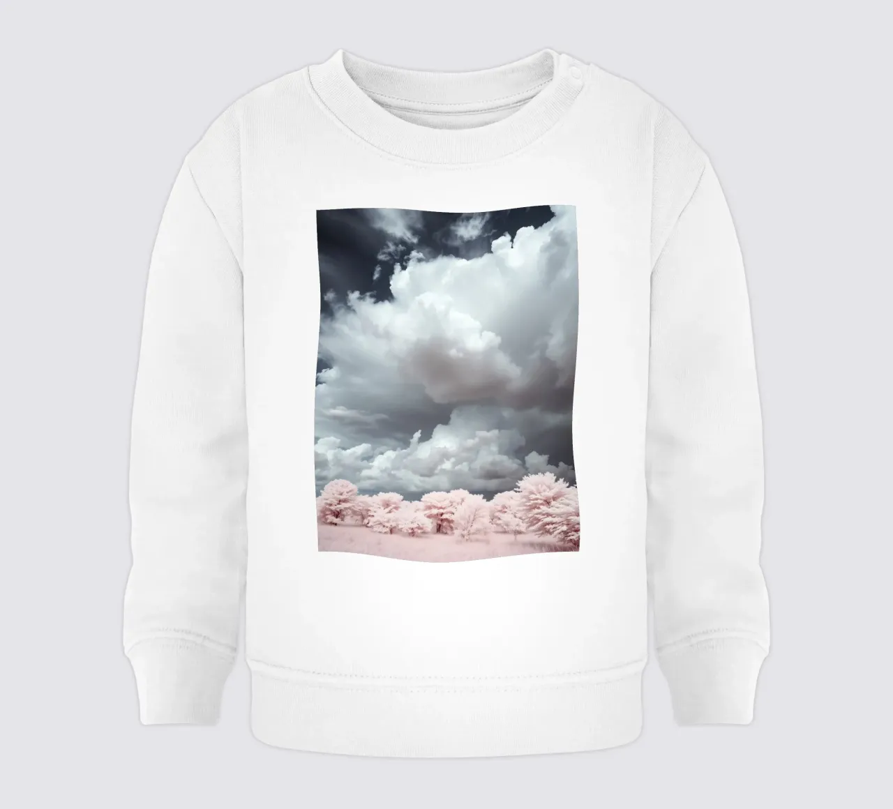 Dramatic clouds hover over pink-tinted trees in an enchantin baby sweatshirt by DesignDoodle