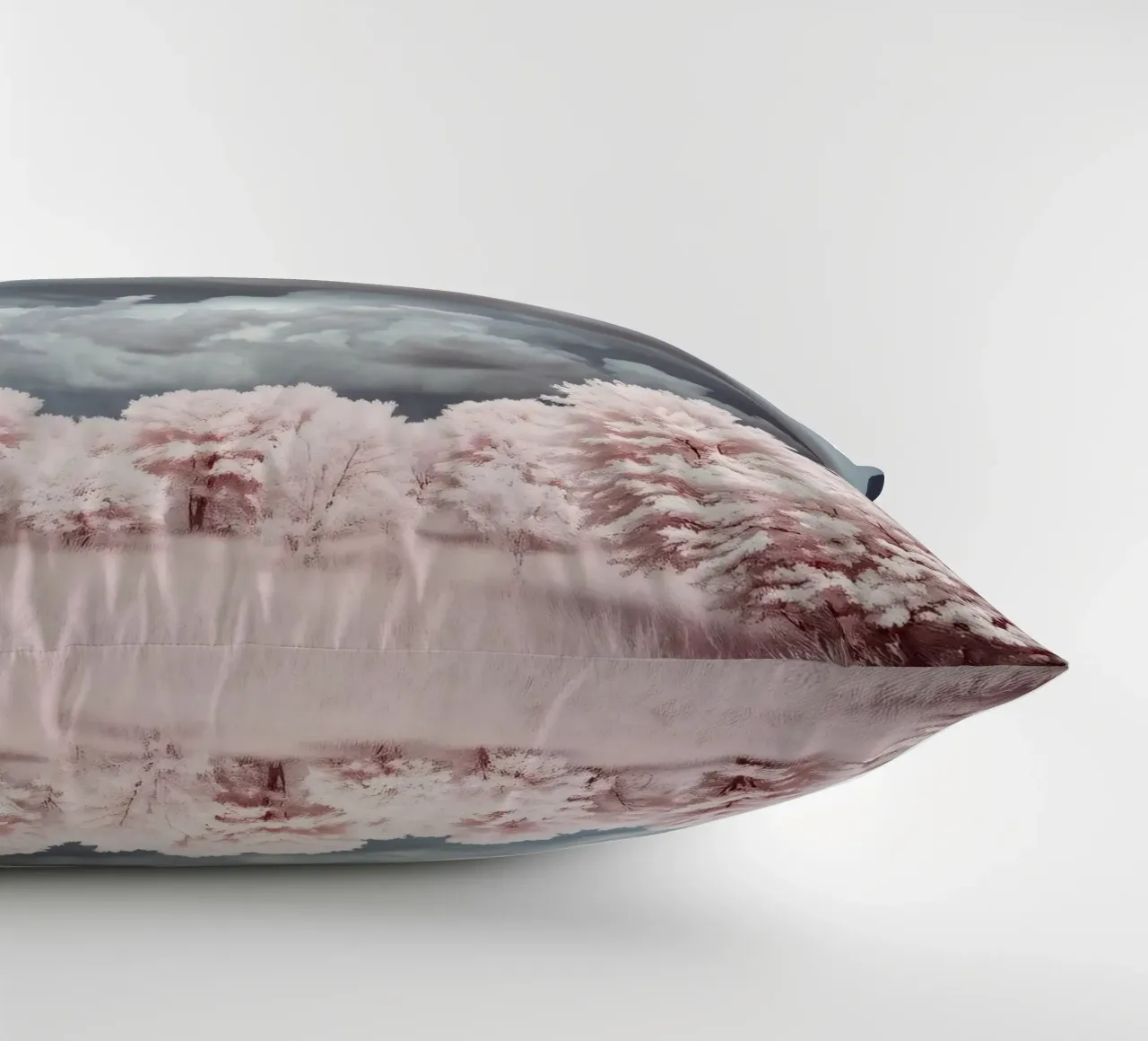 Dramatic clouds hover over pink-tinted trees in an enchantin decorative cushion by DesignDoodle