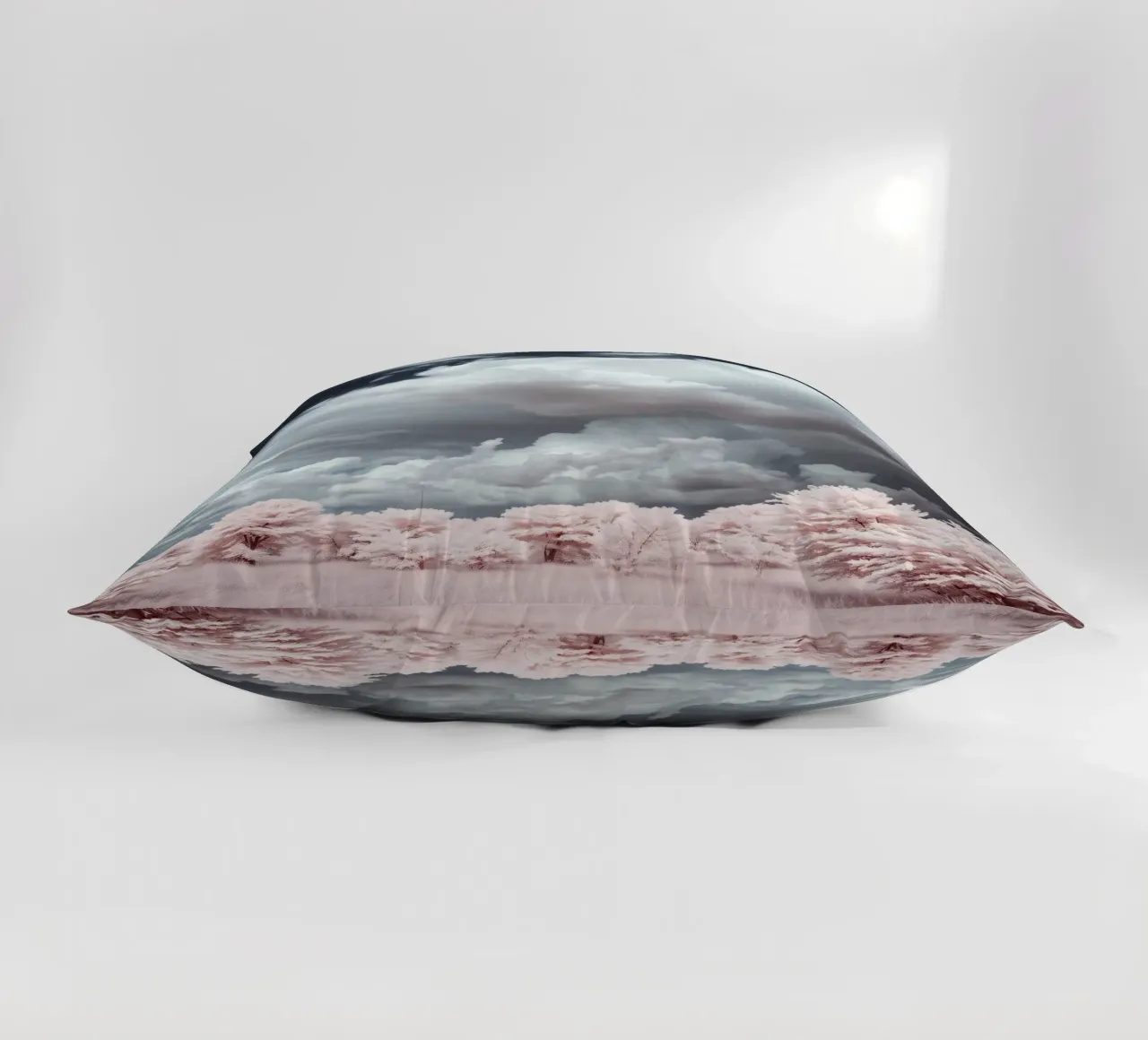 Dramatic clouds hover over pink-tinted trees in an enchantin decorative cushion by DesignDoodle