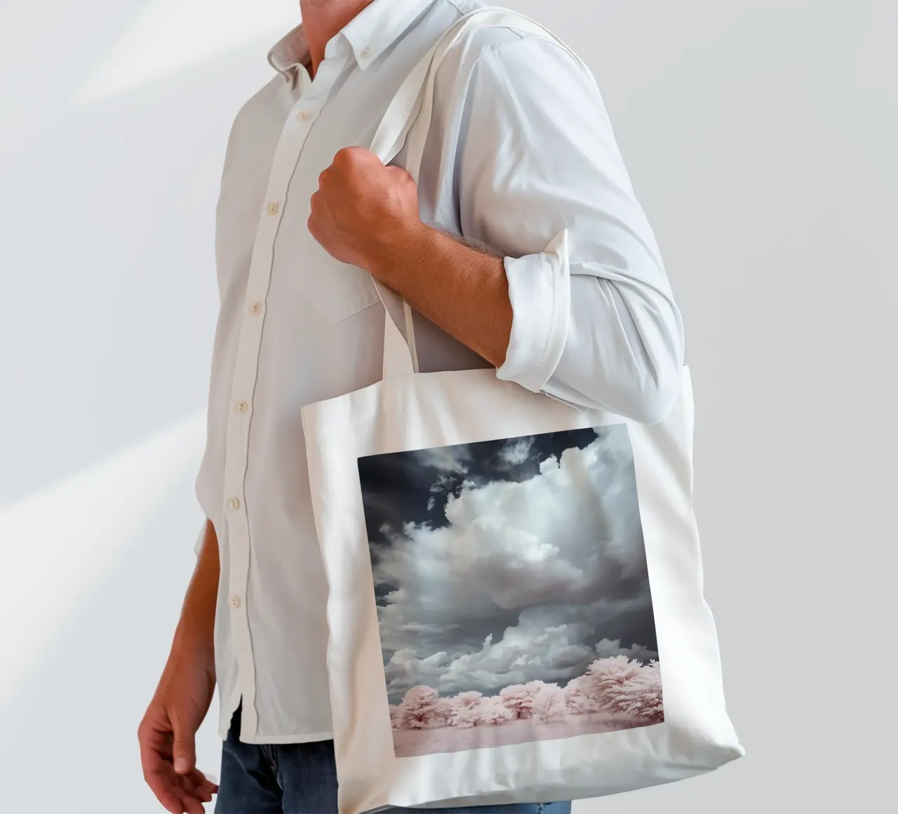Dramatic clouds hover over pink-tinted trees in an enchantin tote bag by DesignDoodle