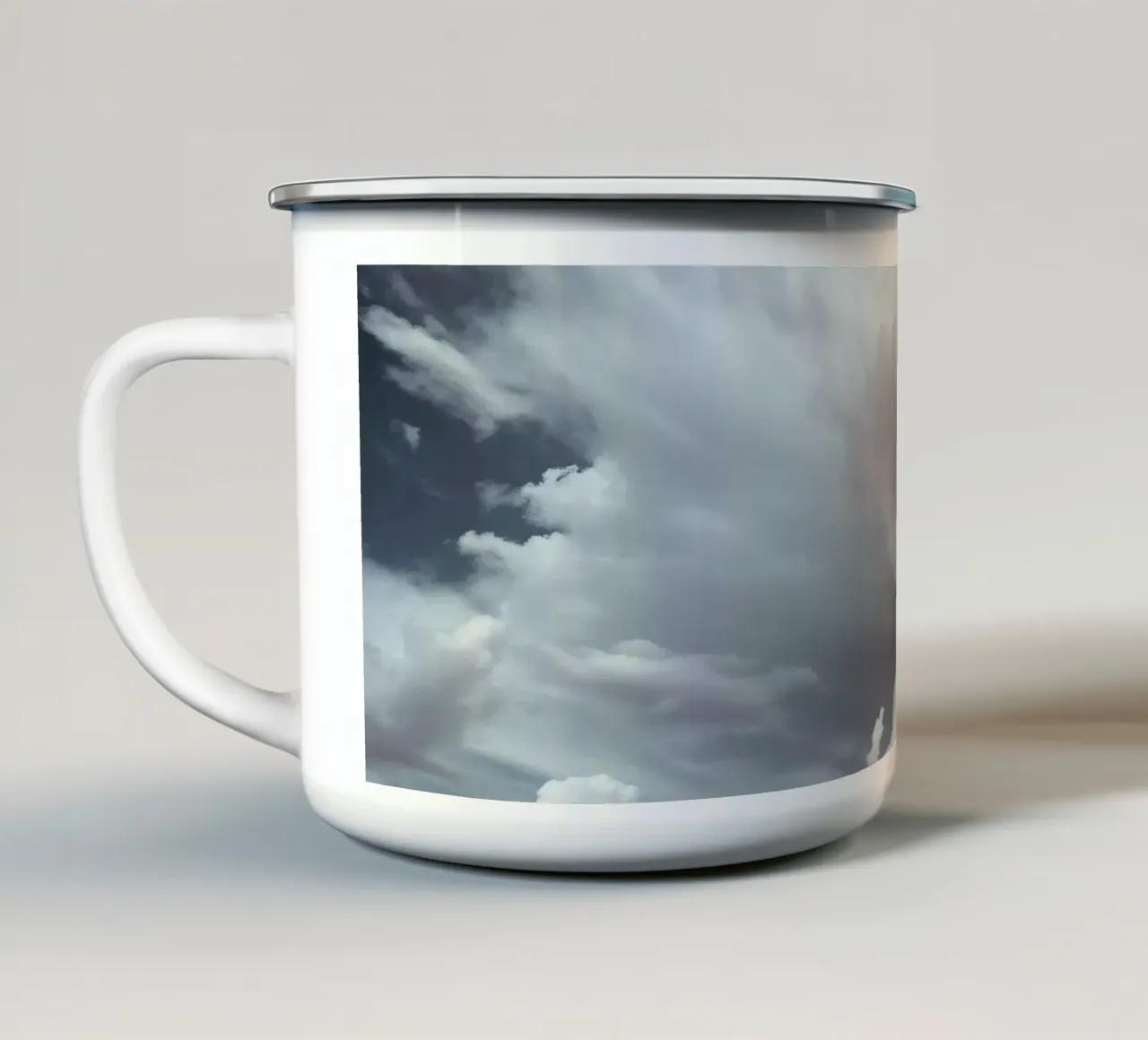Dramatic clouds hover over pink-tinted trees in an enchantin enamel mug by DesignDoodle