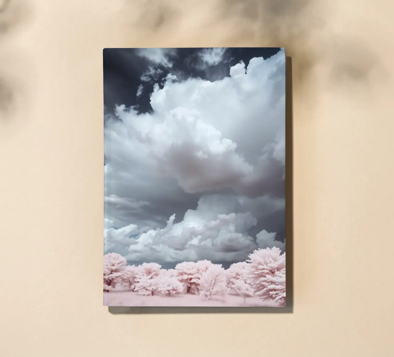 Dramatic clouds hover over pink-tinted trees in an enchantin notebook by DesignDoodle