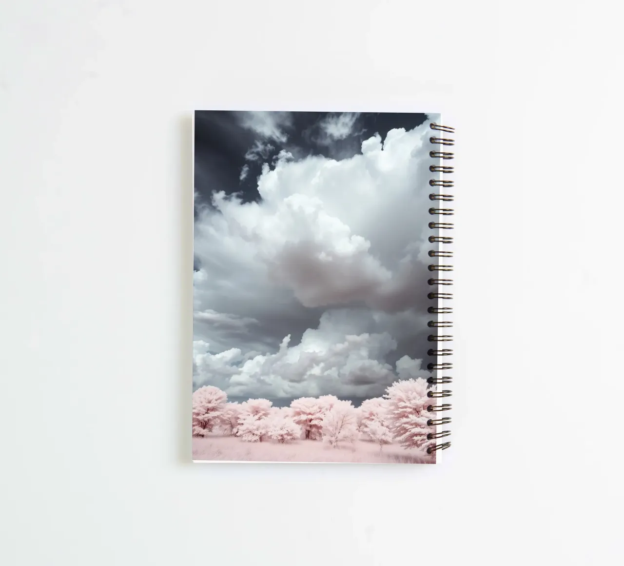 Dramatic clouds hover over pink-tinted trees in an enchantin spiral notebook by DesignDoodle