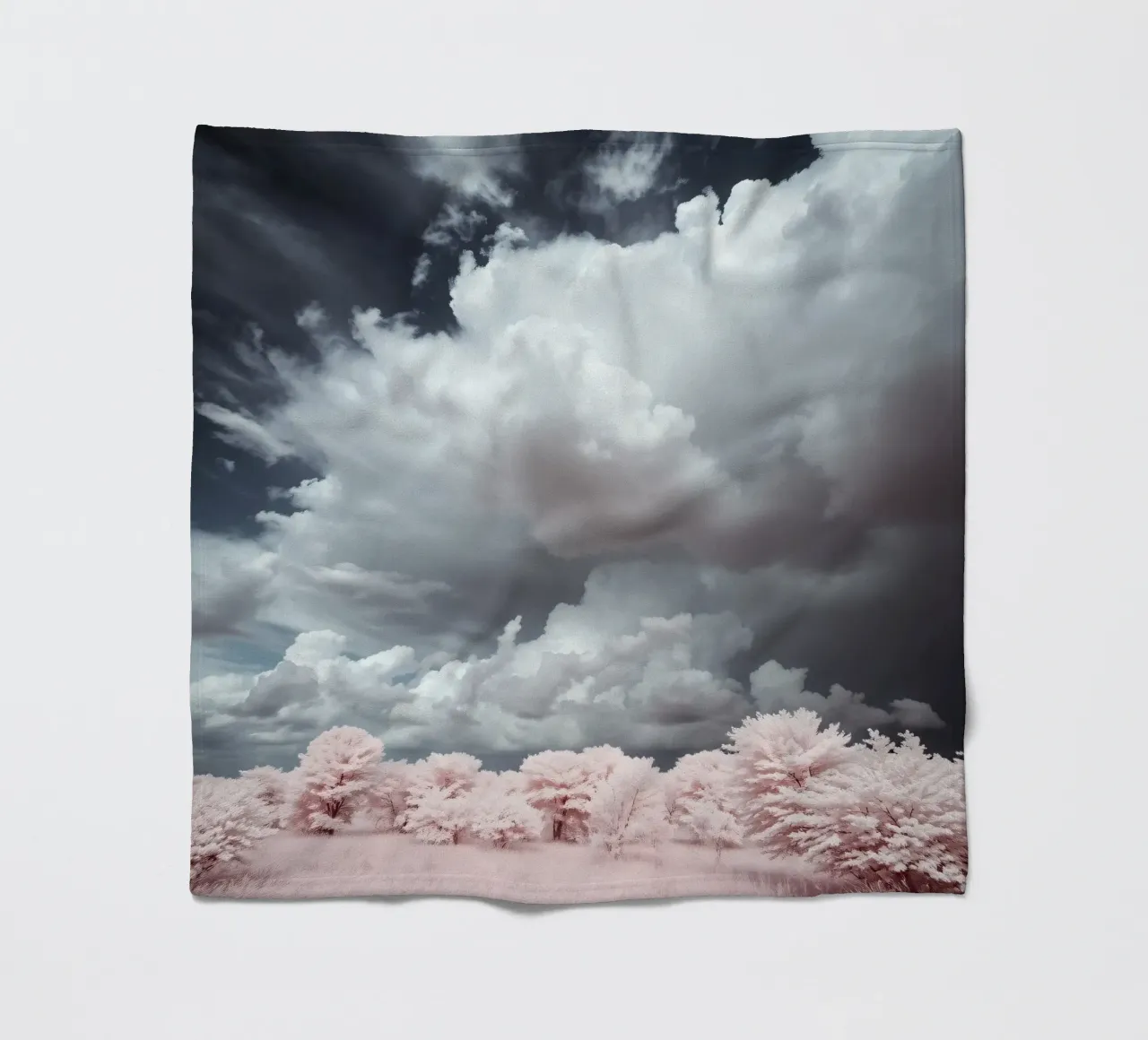 Dramatic clouds hover over pink-tinted trees in an enchantin fleece blanket by DesignDoodle