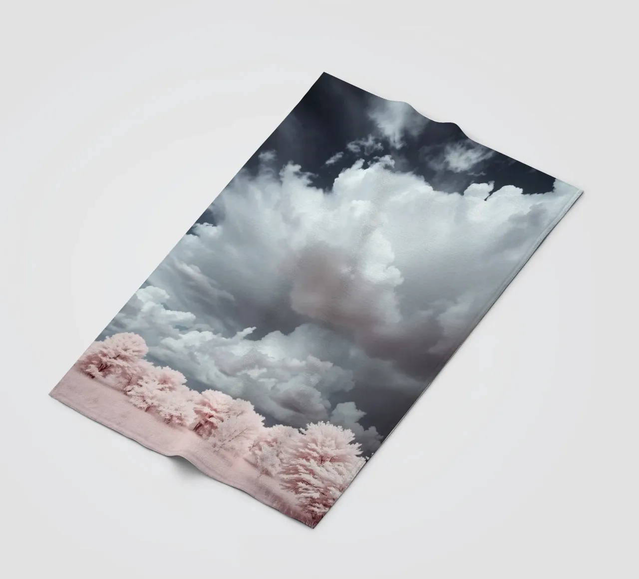 Dramatic clouds hover over pink-tinted trees in an enchantin fleece blanket by DesignDoodle