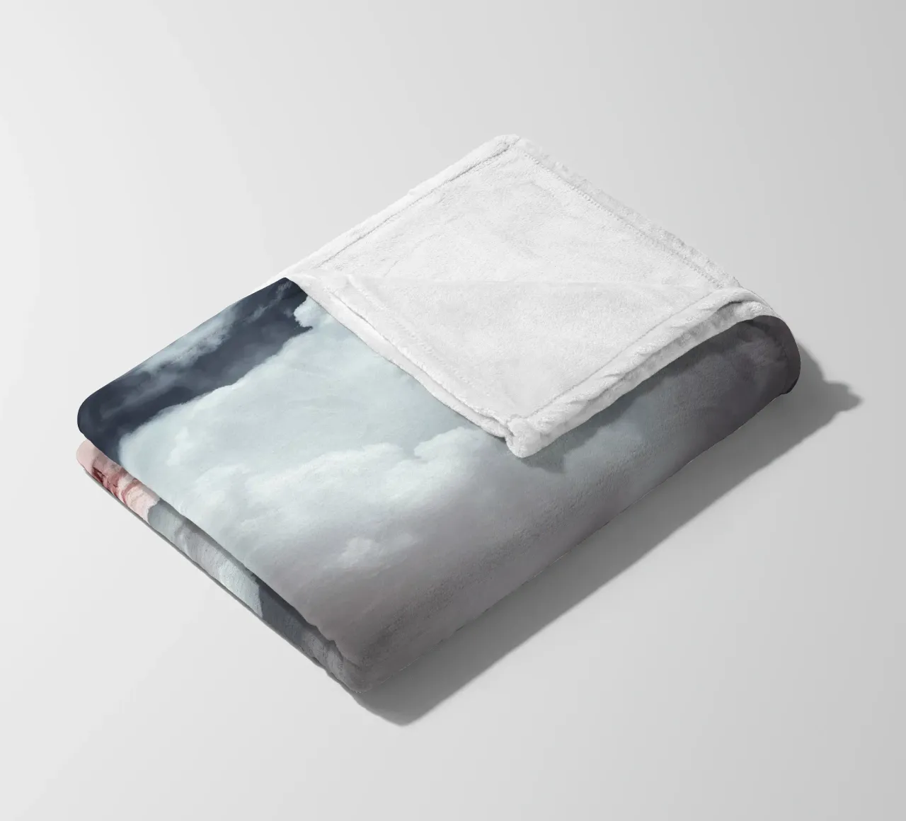 Dramatic clouds hover over pink-tinted trees in an enchantin fleece blanket by DesignDoodle