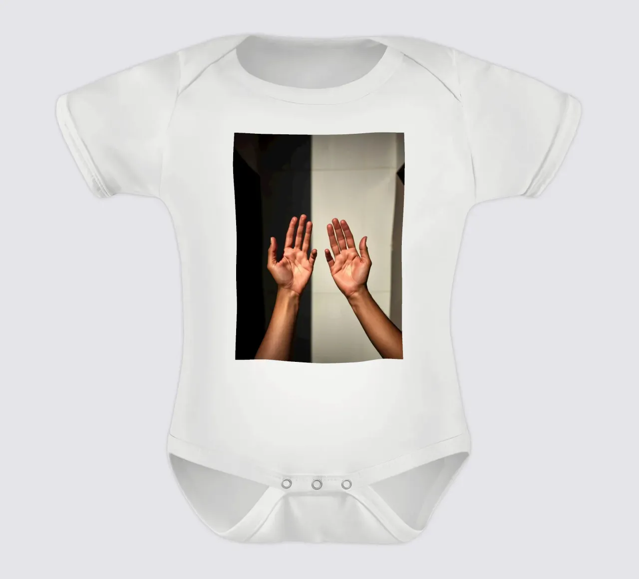 Hands reaching towards light in a minimalist setting short-sleeve baby romper by DesignDoodle