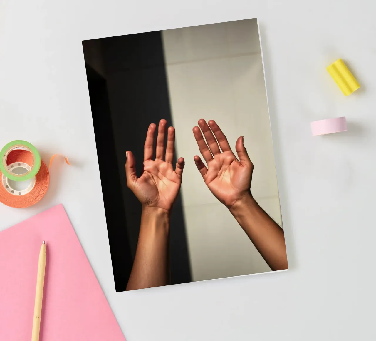 Hands reaching towards light in a minimalist setting notebook by DesignDoodle