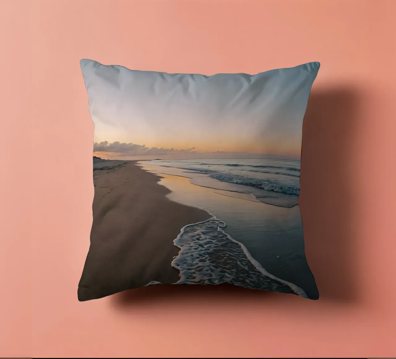 Serene beach at sunset with gentle waves lapping at the shor decorative cushion by DesignDoodle