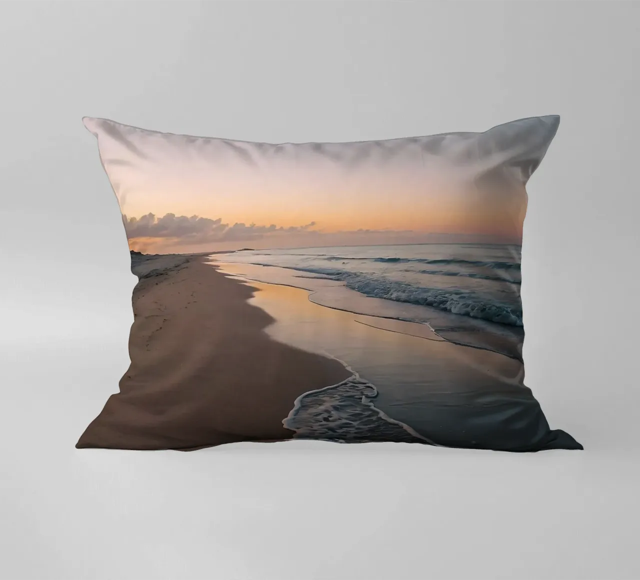 Serene beach at sunset with gentle waves lapping at the shor decorative cushion by DesignDoodle
