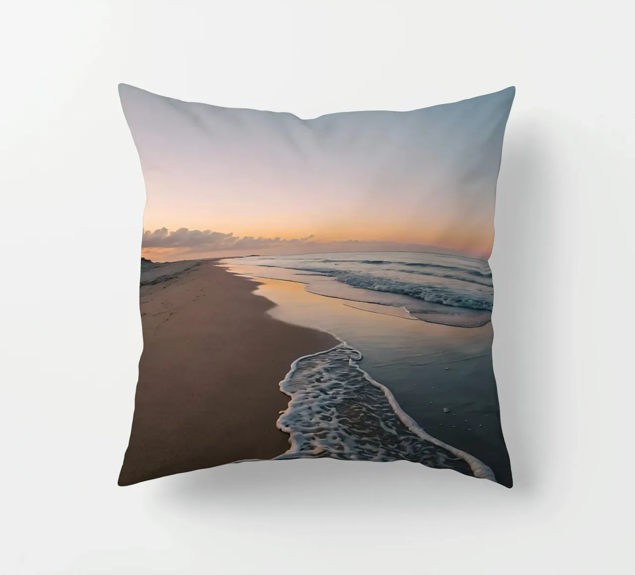 Serene beach at sunset with gentle waves lapping at the shor decorative cushion by DesignDoodle