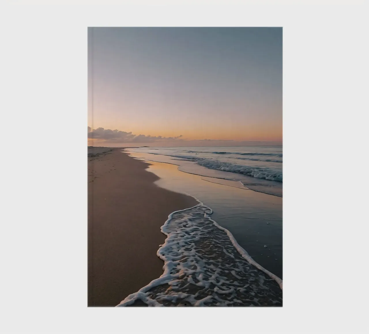 Serene beach at sunset with gentle waves lapping at the shor notebook by DesignDoodle