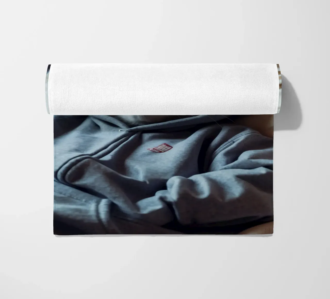 Gatto che riposa comodamente in felpa su un morbido cuscino telo mare da DesignDoodle