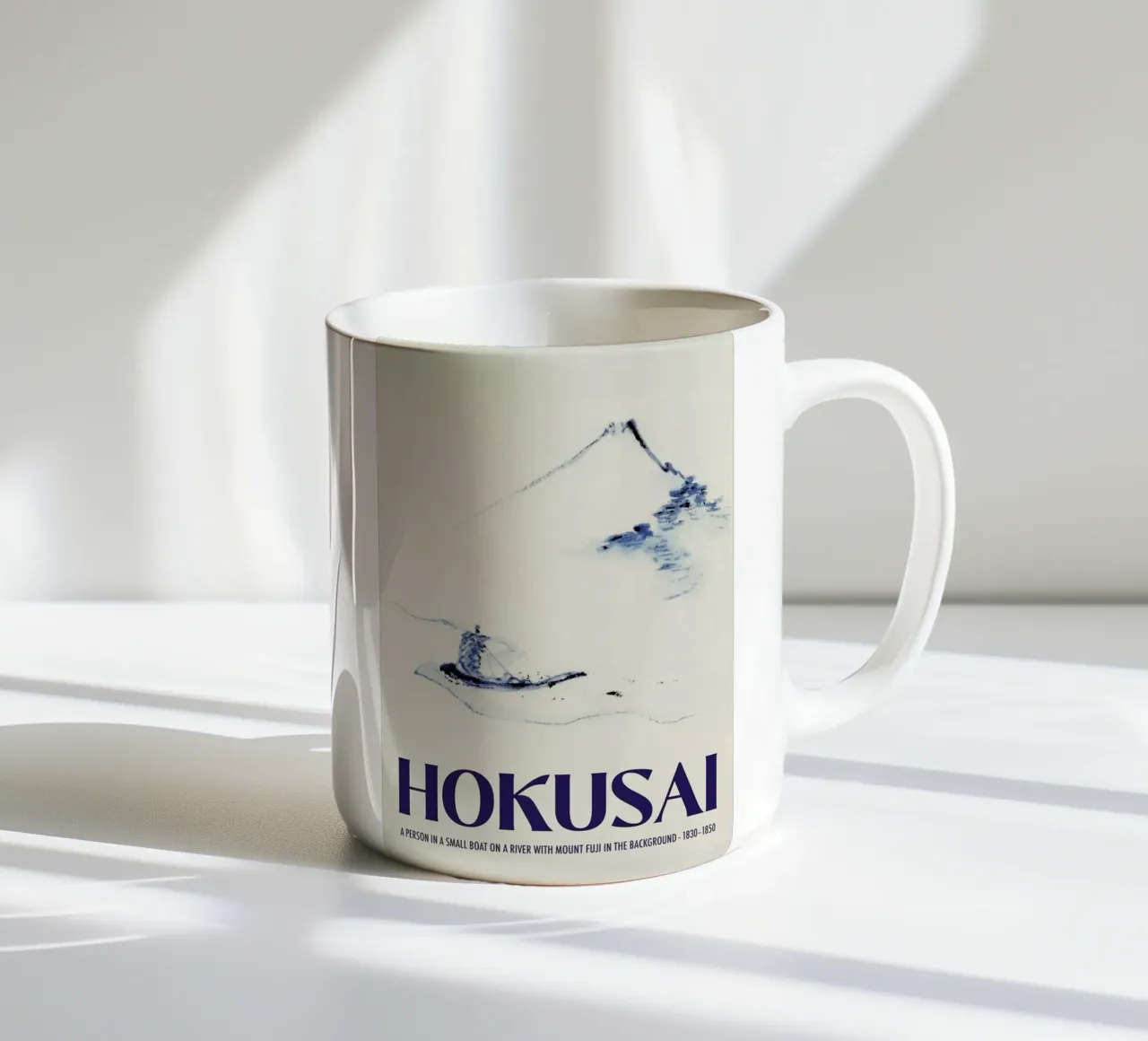 Hokusai - A Person in a Small Boat on a River with Mount Fuji in the Background III taza de cerámica de Vintage by JUNIQE