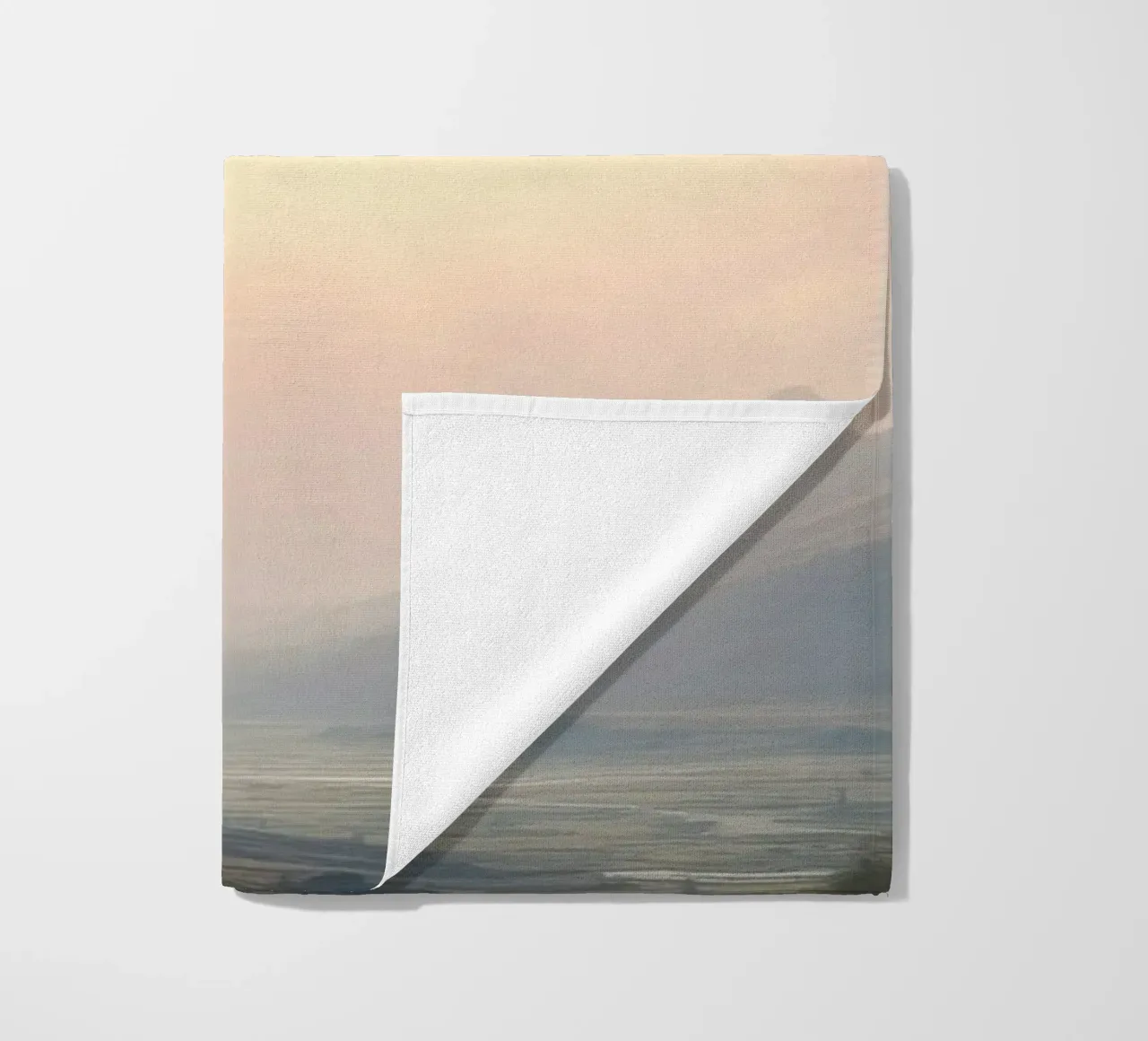 Sunlight breaks through clouds illuminating a calm valley beach towel by DesignDoodle