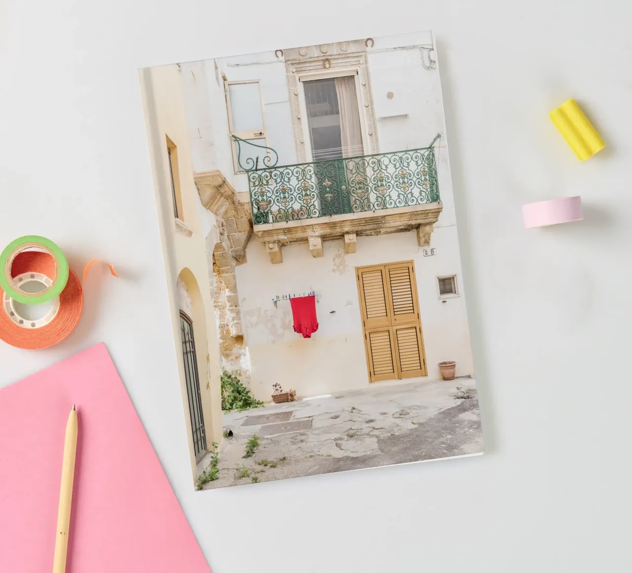 Red shirt and a white building notebook by photolovers