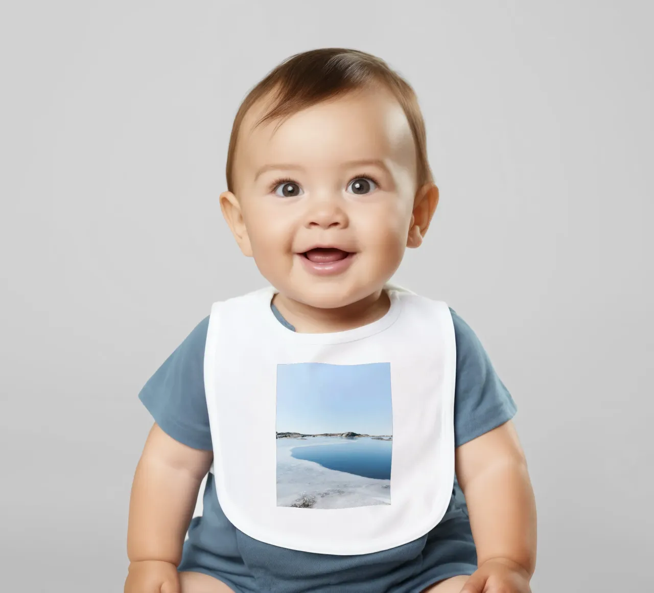 frozen surface lake baby bib by Bleu