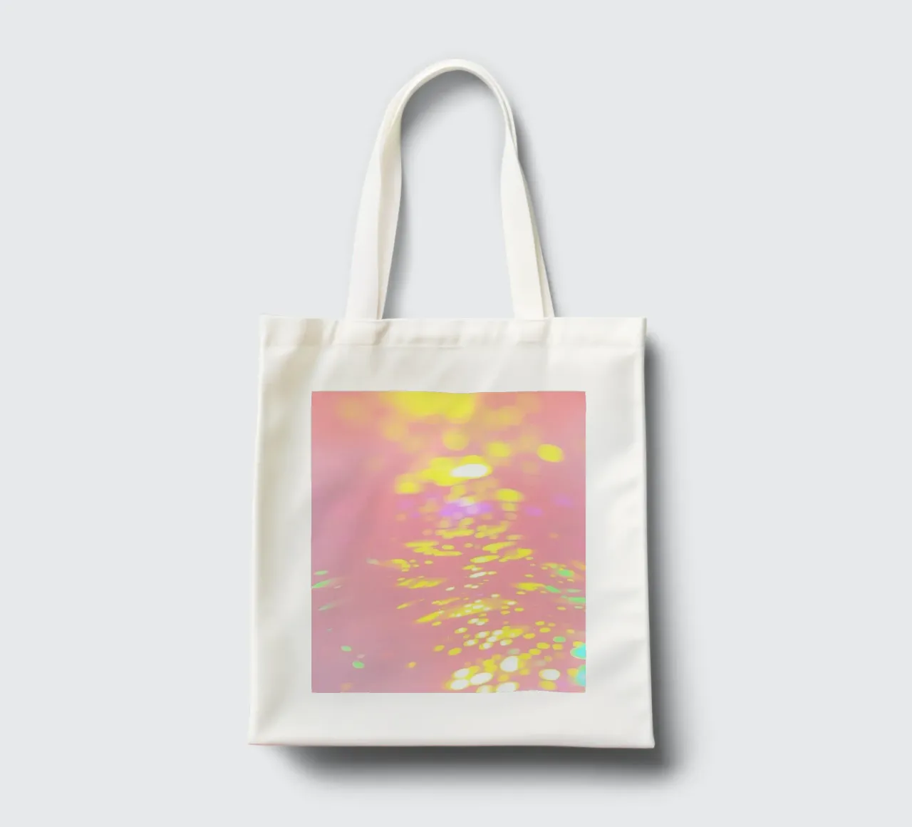 Shimmering reflections of colorful light on a soft pink art tote bag by DesignDoodle