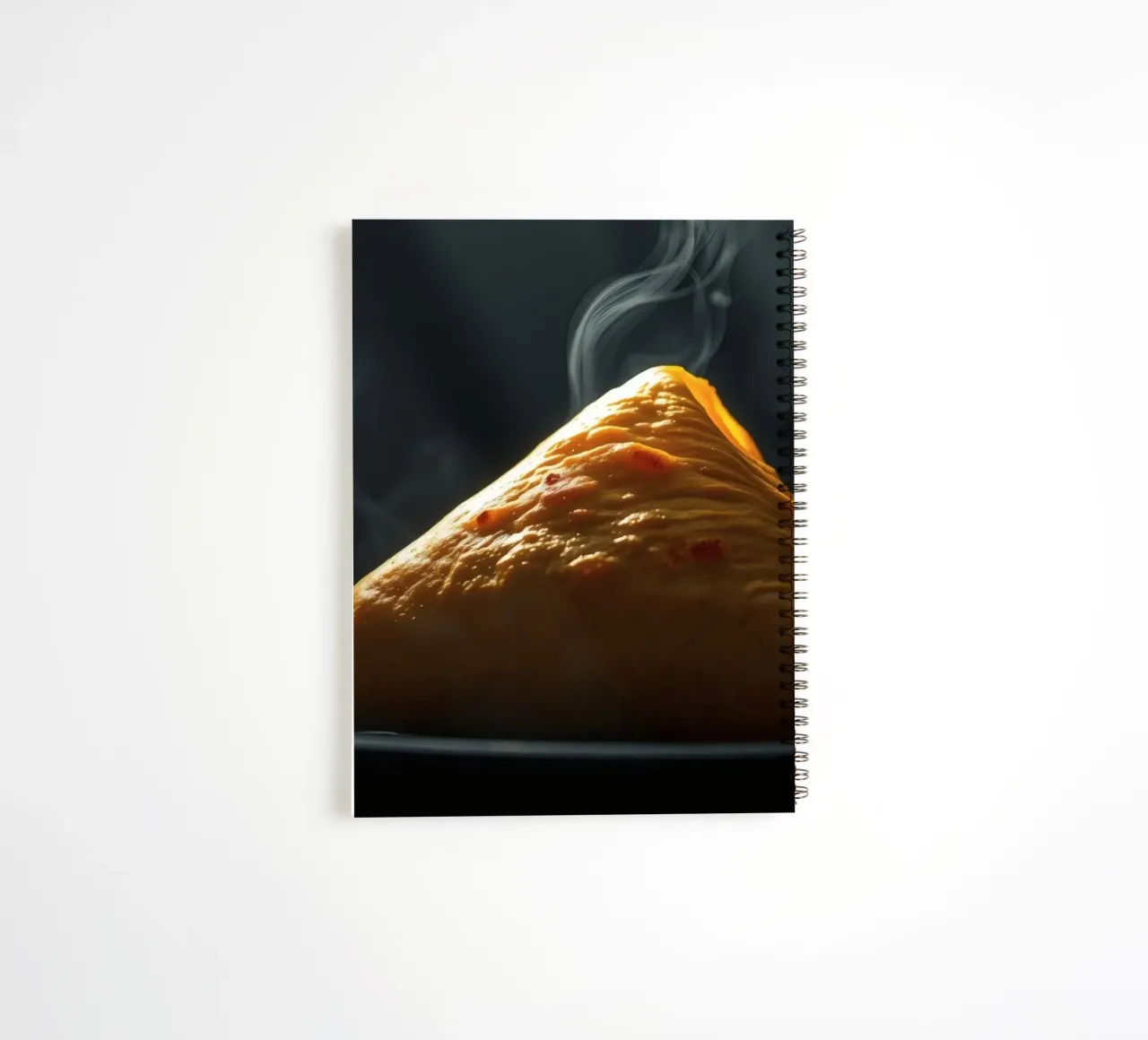Steaming hot samosa displayed on a black plate, dark light spiral notebook by DesignDoodle