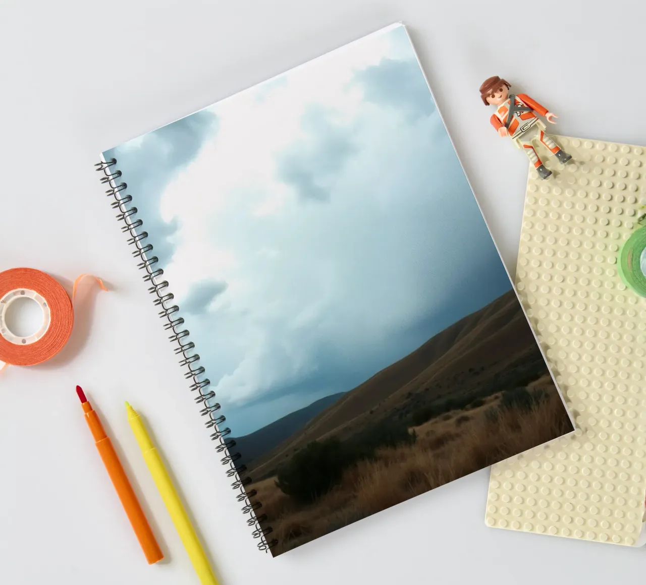 Dark storm clouds gather over a vast landscape spiral notebook by DesignDoodle