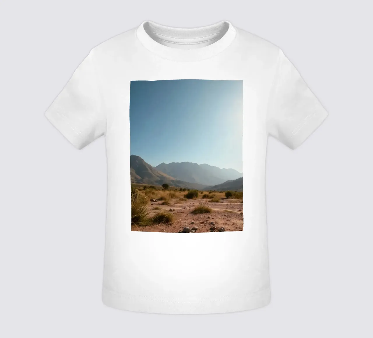 Expansive landscape view of rugged mountains & golden grass baby t-shirt by DesignDoodle