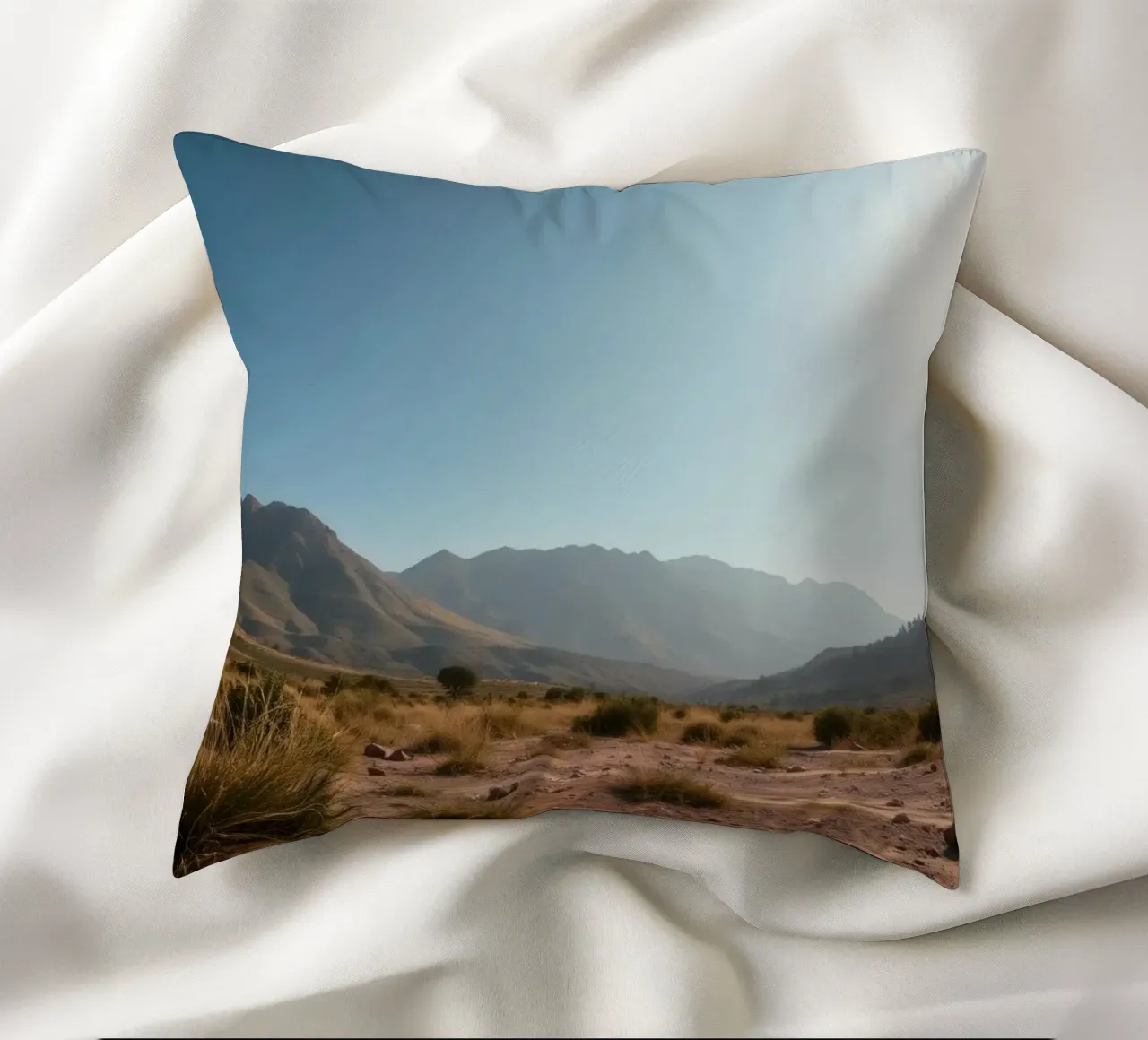 Expansive landscape view of rugged mountains & golden grass decorative cushion by DesignDoodle