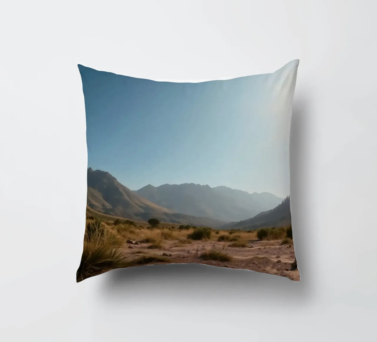 Expansive landscape view of rugged mountains & golden grass decorative cushion by DesignDoodle